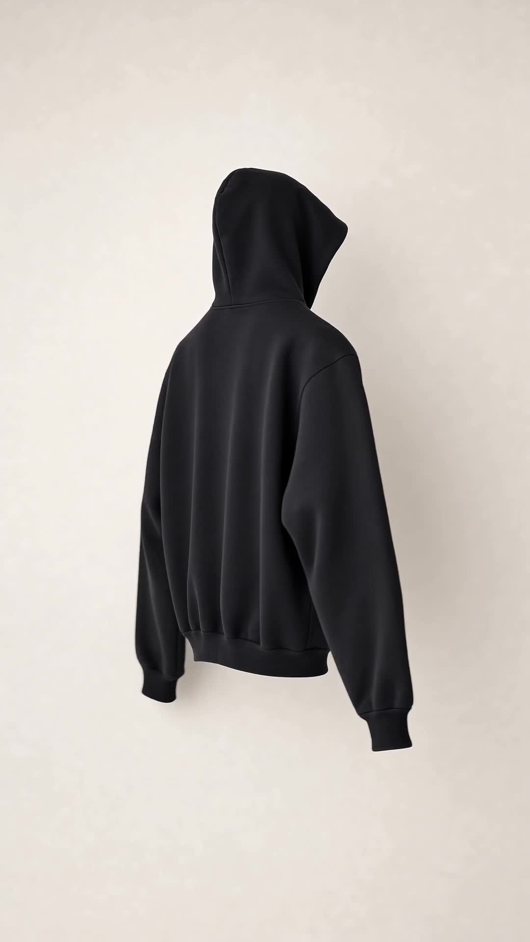 Right-side profile of the SNDGRS STILL. Volume 001 black heavyweight pullover on an off-white background.