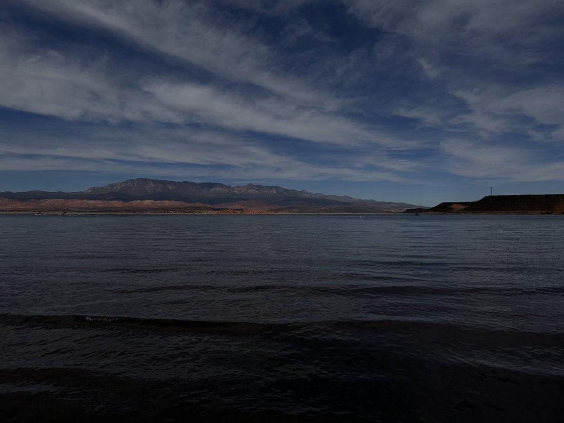 Cloud bands above Sand Hollow Reservoir and red shoreline.