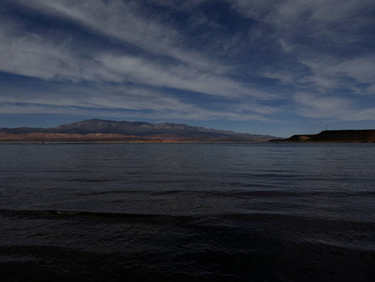 Cloud bands above Sand Hollow Reservoir and red shoreline.