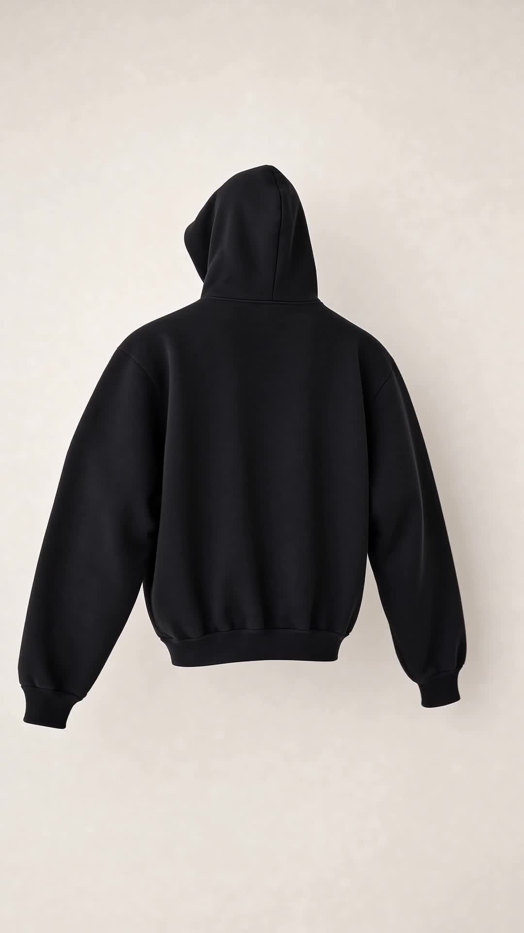 Back view of the SNDGRS STILL. Volume 001 black heavyweight pullover on an off-white background.